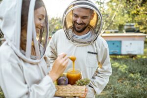 Beekepers with honey on the apiary