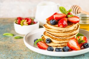 Pancakes with fresh berries and honey